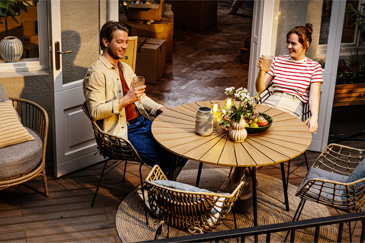 Couple sitting on balcony enjoying a cold bewerage